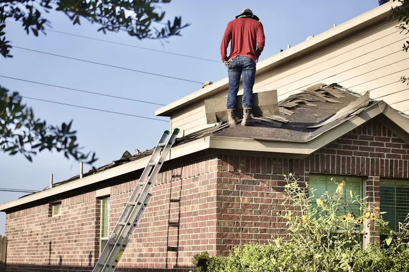 Professional roofer working on a residential roof in New Paris